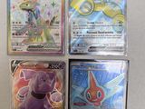 four different pokemon cards sitting on top of each other on a table