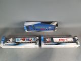 three boxed train cars sitting on top of a table next to each other