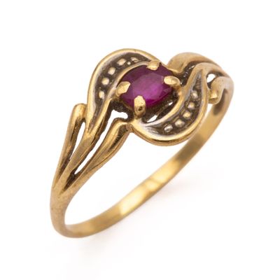 a close up of a gold ring with a ruby stone
