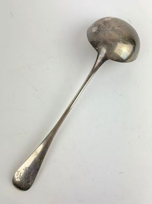 silver spoon on a white surface with a small spoon sticking out of it