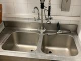 two sinks in the kitchen with a faucet on the counter