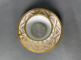an image of a cup and saucer sitting on top of a table