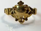 an image of a close up of a gold ring on a white surface