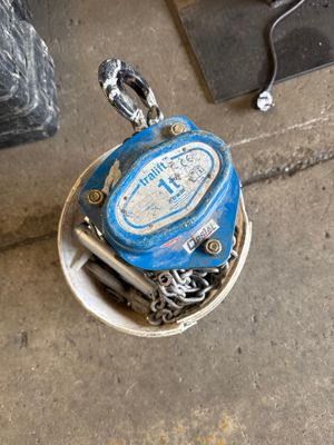 a blue fire hydrant sitting on the ground next to a black fire hydrant