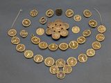 a gold plated necklace and bracelet set with circular medallions