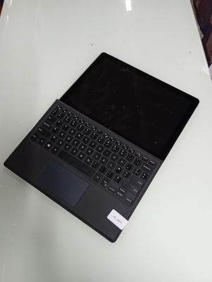 an open laptop computer sitting on top of a white table