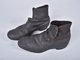 pair of black leather boots with buckles on a white surface