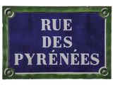 blue and white sign with french words on it saying rue des pyrenes