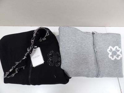 two pairs of black and grey clothing on a white table