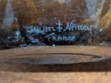 a close up of a glass vase on a wooden table