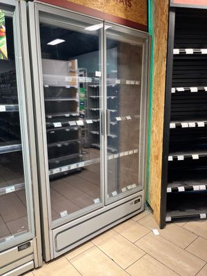 a large display case in the middle of a grocery store