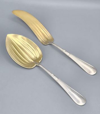 two spoons and a spoon with a banana shaped handle