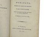 an open book with a black and white image of the title of a poem