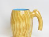 a wooden mug with a handle on a white background