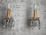 two wall sconces on the wall of a room