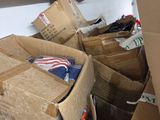 a pile of cardboard boxes in a garage with other boxes