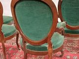 three green chairs are sitting on a red rug on a white background