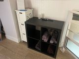 a black shelf with towels on it in a small room