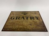 une vieille enseigne en métal sur laquelle est inscrit « Graty »
