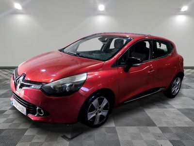 a red car is parked in a room with a checkered floor