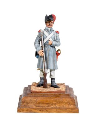 figurine of a soldier with a rifle on a wooden base