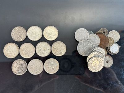a lot of coins sitting on a table next to each other