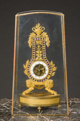 a glass case with a clock inside of it on a table