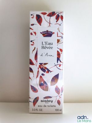 a close up of a bottle of perfume on a table