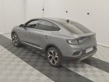 the rear end of a grey car is parked in a garage