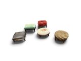 four small stools and a small ottoman on a white surface