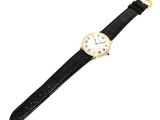 an image of a black and gold watch with a white face