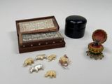 a small wooden box with elephants and other items on the table