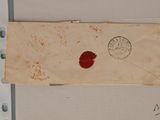 a piece of paper with a red wax stamp on it