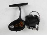 a close up of a fishing reel on a white surface