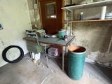 a room with a table and a trash can in it