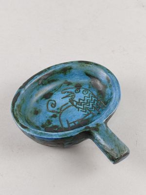 un petit bol bleu orné d'un motif de poisson
