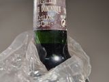 a bottle of wine wrapped in plastic on a table