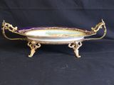 a gold and purple serving dish on a black background