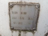 a metal plaque on the side of a white tank