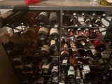 many bottles of wine in a wine rack on the counter