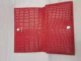 a red leather wallet on a white background
