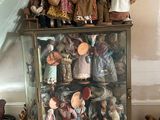 a display case full of dolls in a room