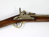 an old gun with a wooden handle on a white surface