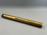a brass colored pen sitting on top of a white table