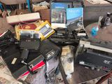 a lot of electronics on a table in a room
