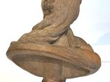 a statue of a woman sitting on top of a bust