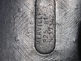 the bottom of a black leather purse with a metal handle