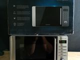 a box on top of a microwave on a wooden table