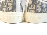 the shoes are white and blue with a pattern on them