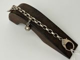 a close up of a metal chain on a wooden block